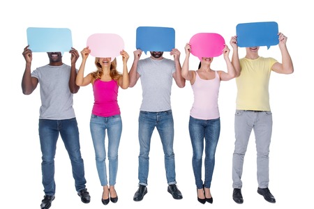 Kidding. Good-looking exuberant young best friends smiling and holding tables and standing in a line and wearing casual clothesの写真素材