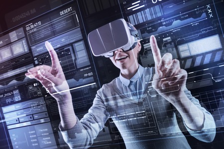 Sudden idea. Excited emotional professional programmer feeling happy while wearing virtual reality...