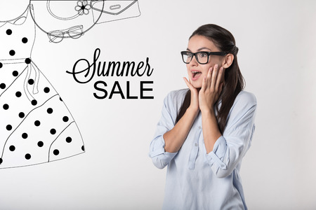Summer sale. Excited young woman putting her hands to her face and feeling surprised while noticing unbelievable summer sale in her favorite shopping mallの写真素材