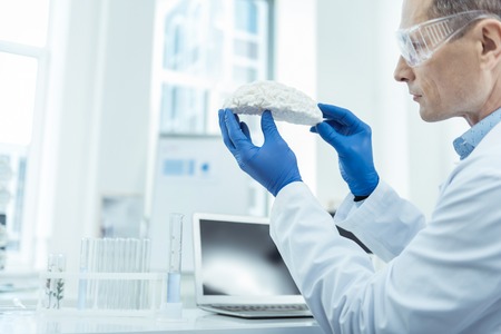 Detect disorders. Close up of brain scan in hands of a professional neurosurgeonの写真素材