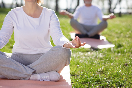 Lotus pose. Nice pleasant woman meditating while sitting in the lotus poseの写真素材