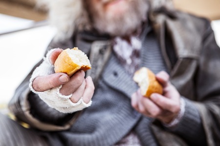 My food. Selective focus of bread pieces being held by a nice hungry man