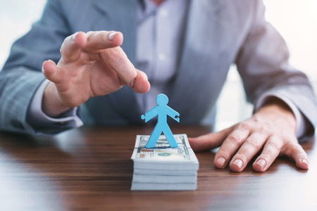 Politic game. Immoral successful official holding money and playing with statuetteの写真素材