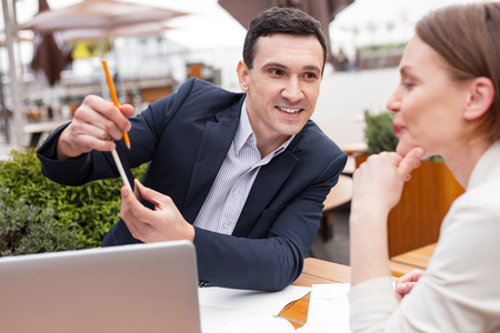 Industrious chef. Successful industrious chef feeling involved in explaining some important work issues to his colleagueの写真素材