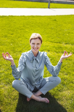 Relieved businesswoman. Smiling experienced businesswoman feeling extremely relieved while sitting...
