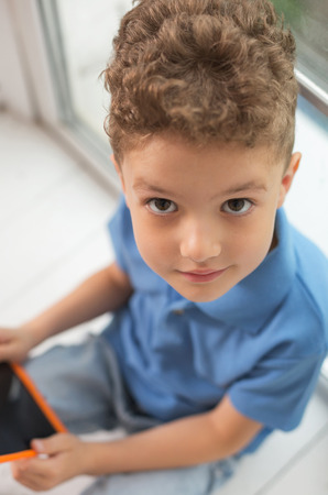 Look into eyes. Dark-eyed little cute boy looking into eyes of his lovely beautiful mother while asking her buying new toysの写真素材