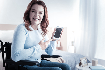 Charming female person expressing positivity while looking at cameraの写真素材