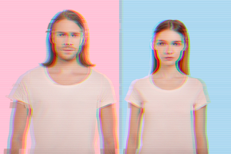 Serious people. Calm serious couple wearing similar clothes and looking calm while standing against...