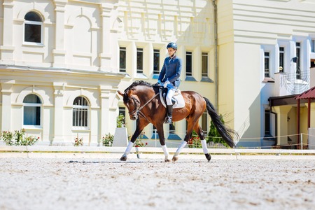 Promising professional horse man wearing black leather riding boots sitting on his horseの写真素材