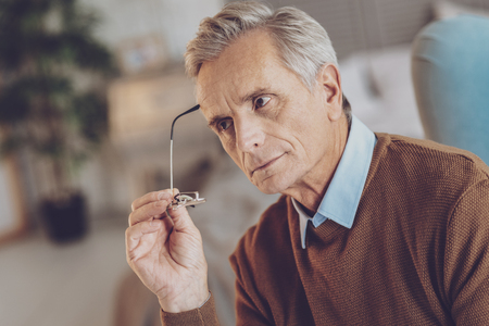 Attentive pensioner spending time at home while thinking about projectの写真素材