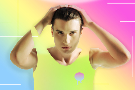 Sportswear. Calm young sports trainer putting hands on his head and wearing new bright sports...