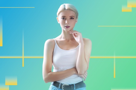 Casual clothes. Pretty cheerful student touching her face and wearing casual clothes while getting...