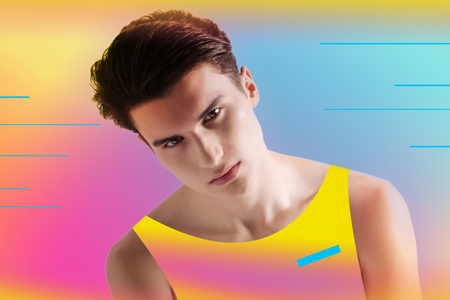 New clothes. Calm young man feeling confident while wearing new colorful clothes