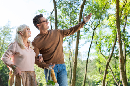 Nature inspired. Happy people keeping smile on faces while looking in one directionの写真素材