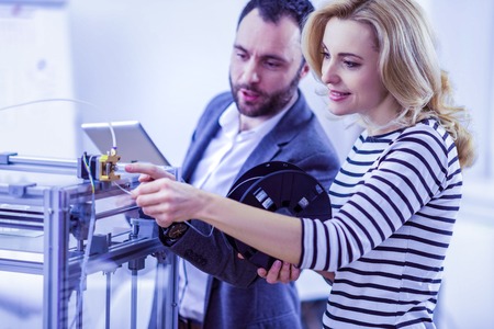 Collective work. Amazing engineer expressing positivity while standing near her partner