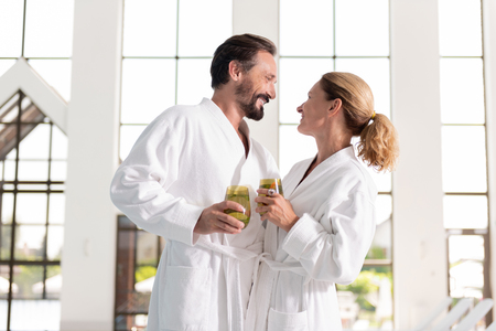 Joyful time. Happy nice couple looking at each other while enjoying their time togetherの写真素材