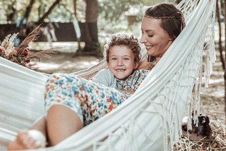Happy family. Sweet nice mother and son spending time together resting in park