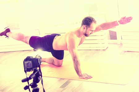 Healthy way of life. Strong nice man exercising while being in front of the camera