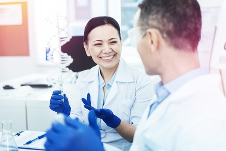 Happy nice smart scientists making new discoveries while working in the labの写真素材