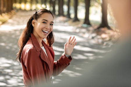 Kind female person expressing positivity while communicating with her friendの写真素材