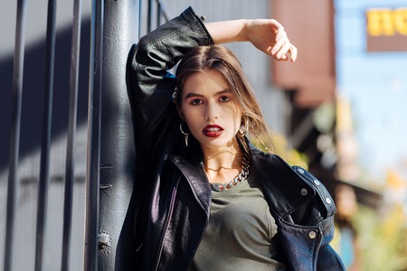 Dark red lips. Close up of trendy charming dark-eyed photo model with dark red lips posing for coverの写真素材