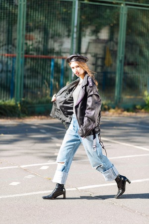 Close up of dark-eyed young beautiful model walking outside on the streetの写真素材