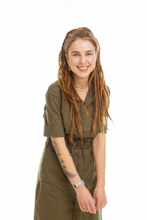 Modern look. Cheerful positive woman smiling to you while having unusual hairstyle