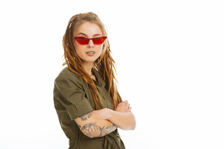 Modern youth. Confident stylish woman standing cross handed while looking at you
