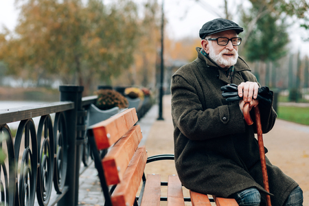 Feeling happiness. Pleased senior man thinking positive while enjoying nature in parkの写真素材