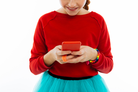 Modern gadgets. Close up of a modern innovative smartphone being in hands of a nice pretty girlの写真素材