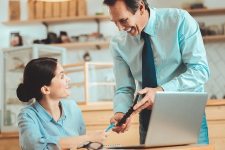 Feeling satisfied. Happy smart business people calculation financial indicators having big profit of their start upの写真素材