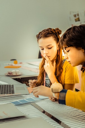 Shade of blue. Creative artistic schoolchildren having hesitations while choosing shade of blueの写真素材