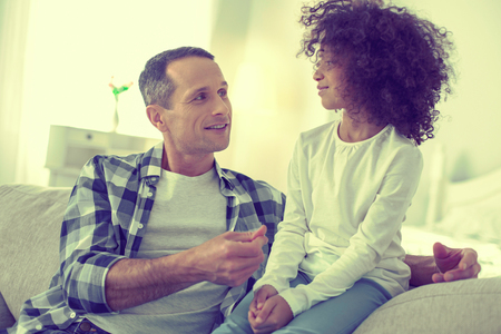 Imparting wisdom. Wise father telling his curious daughter interesting facts.の写真素材