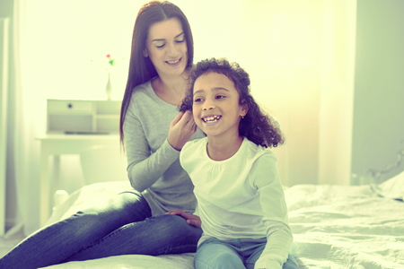 New hairstyle. Little happy child enjoying her day with her mom.