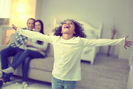 Self-expression. Energetic playful kid loudly showing her joy.の写真素材
