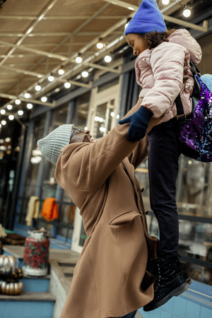 Girl on hands. Loving beaming father feeling simply amazing while holding his cute little girl on handsの写真素材