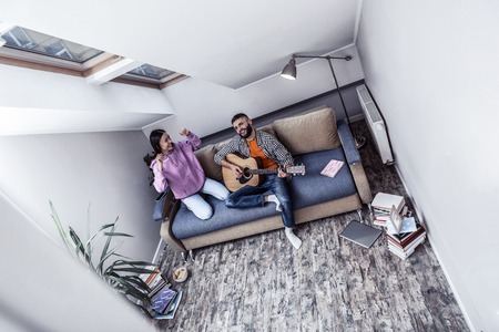 Leisure time. Top view of a happy nice couple being in the attic room