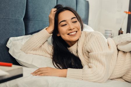 Energetic and motivated. Cheerful Asian woman feeling energetic and motivated in the morningの写真素材