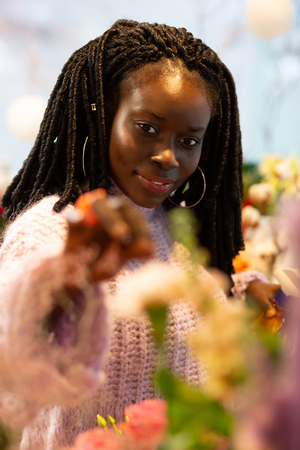 Professional hobby. Delighted female expressing positivity while touching flowersの写真素材