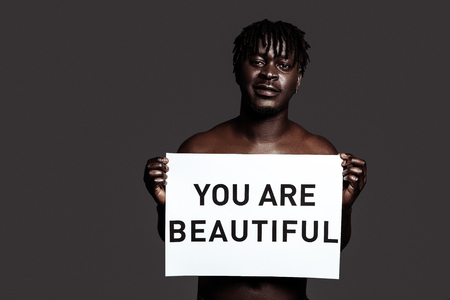 Feel confident. African-American man with dreadlocks engaging people to feel confident and to love themselvesの写真素材