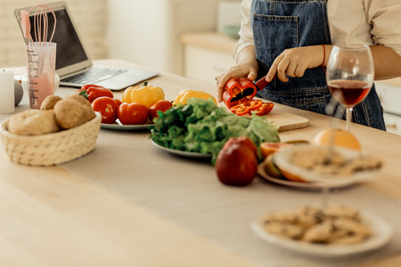 Kitchen. Cute young red-haired girl wearing rings on her fingers spending time in the kitchenの写真素材