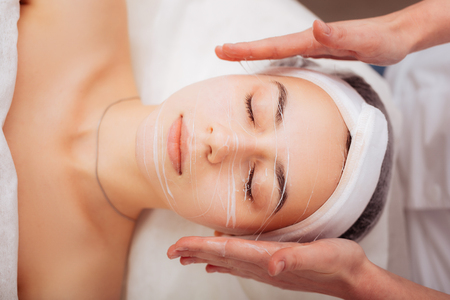 Power firmer. Top view of a female face with a special cream on itの写真素材