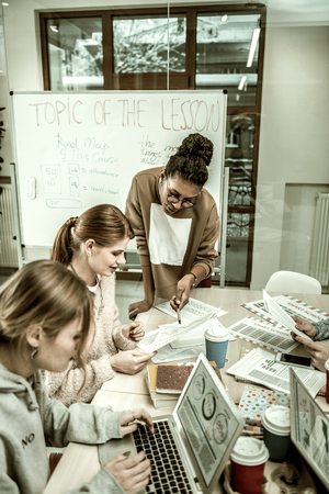 Team leader. Team leader wearing glasses asking their students controversial questionsの写真素材
