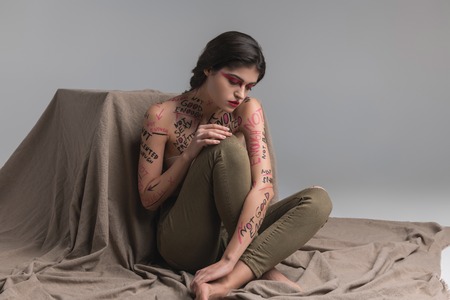 Mysterious woman. Brunette cute young model wearing skinny jeans looking mysterious
