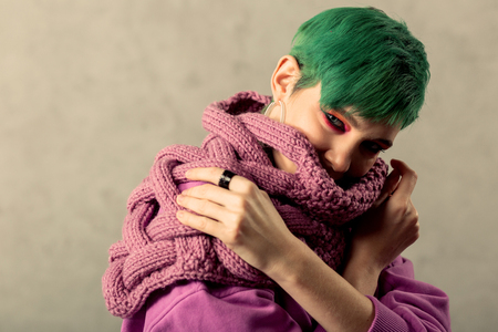 Magnetic look. Nice green haired woman looking at you while wearing a green scarfの写真素材