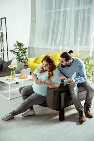 Look here. Bored young woman having passive life and suffering bulimiaの写真素材