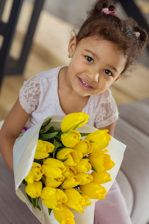 For my mom. Charming international child expressing positivity while posing on cameraの写真素材