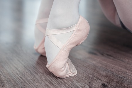 Dancing position. Close up of a female feet standing on the toes while dancing