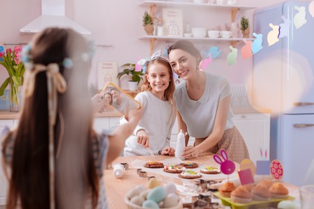 Look at us. Charming brunette woman feeling happiness while spending weekend with her kids