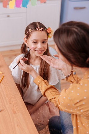 Good idea. Cheerful teenager keeping smile on her face while looking aside
